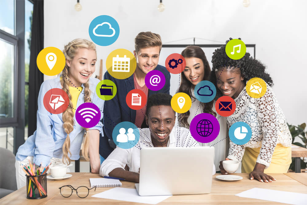 Group of employees looking at a computer
