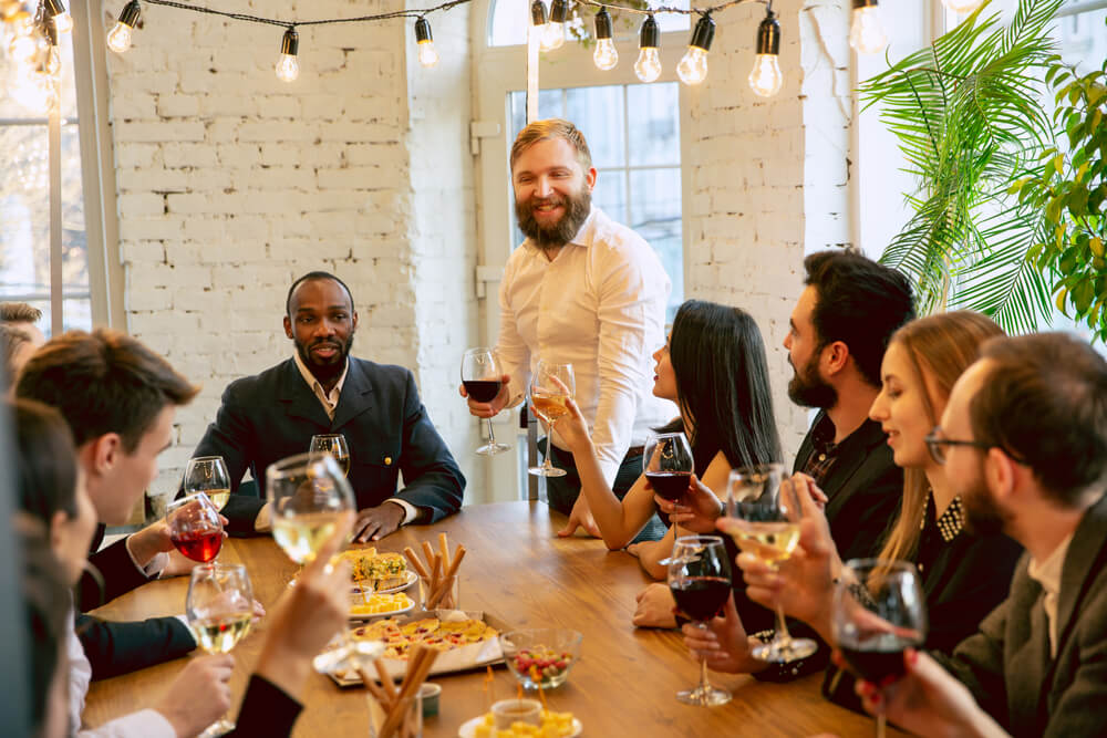 Group of happy employees enjoying company dinner