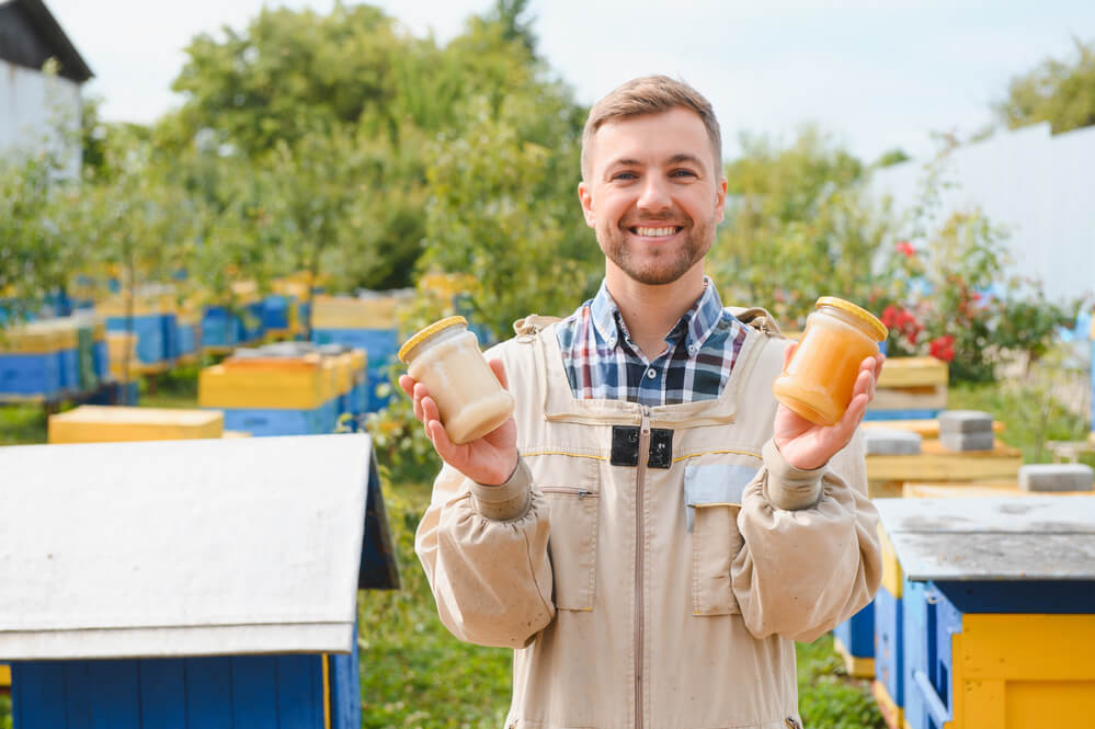 beekeeper holding honey jar